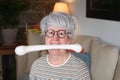 Hilarious senior woman holding bone with mouth