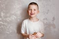 Hilarious smiling seven-year-old child with pancakes in his hands