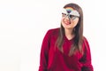 Hilarious youthful European woman wearing funny rainbow glasses and smiling at camera. Medium studio shot over white