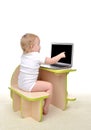 ÃÂ¡hild baby girl toddler sitting computer laptop pointing finget at display Royalty Free Stock Photo