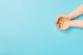 ÃÂ¡hild hands holding green dove bird on blue background, international day of peace or world peace day concept Royalty Free Stock Photo