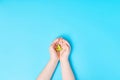 ÃÂ¡hild hands holding yellow dove bird on blue background, international day of peace or world peace day concept Royalty Free Stock Photo