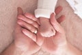 Babies palm in parents hands. Happy Mother& x27;s and Father& x27;s Day. Childhood and parenthood Royalty Free Stock Photo