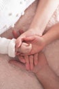 Babies palm in parents hands. Happy Mother's and Father's Day. Childhood and parenthood Royalty Free Stock Photo