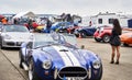 Classic blue Cobra Roadster entering the starting grid for a race with classic cars