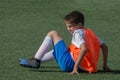 hildren football. Opponent hit the young football player in the legs. Very painful Royalty Free Stock Photo