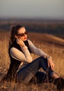 Nice,excellent,awesome girl,woman,model sits on the hill with beautiful,wonderful view.Luxury girl with sunglasses watching sunset