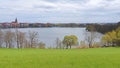 a wide view from the hill above the lake to the small town on the other side Royalty Free Stock Photo