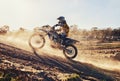 Hill, race and man on dirt bike in desert with adventure, adrenaline and speed in competition, Extreme sport, dust and Royalty Free Stock Photo