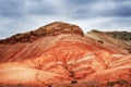 The hill is red yellow and white clay, ancient multi-colored deposits.