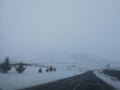 Hill road landscape in winter at Iceland. Asphalt road with sideways full of snow. Royalty Free Stock Photo