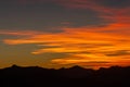 Hill silhouettes under a cloudy sky during a breathtaking sunset in Patagonia, Argentina Royalty Free Stock Photo