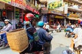 Hill tribe woman carry basket on her back and sit in back seat of motorcycle at the market area in summer in Sa Pa, Vietnam