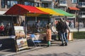 04.18.2023 Hillegom, Netherlands. Tourists and Dutch people interested in art market stall selling paintings. Stall