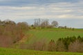 Hills of the Ardennes, with meadows and trees under a cloudy sky Royalty Free Stock Photo