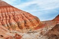 The hills and mountains of ancient sediments with patterns of erosion, red yellow and white clay Royalty Free Stock Photo