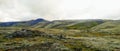 Hills mountains Iceland landscape green grass cliff stones rain clouds