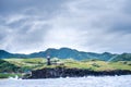 Hills of Sabtang Island with Lighthouse fronting the shore at, Batanes, Philippines