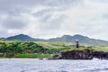 Hills of Sabtang Island with Lighthouse fronting the shore at, Batanes, Philippines Royalty Free Stock Photo