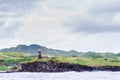 Hills of Sabtang Island with Lighthouse fronting the shore at, Batanes, Philippines Royalty Free Stock Photo