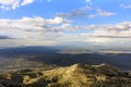 Hills in warm evening light with barren vegetation against blue sky and white clouds, Biokovo Nature Park Royalty Free Stock Photo