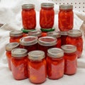 Stack of Kerr canning jars with homemade tomato paste and carrots in tomato juice