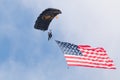 Parachutist jumping down with American flag