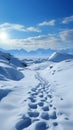 Hillside journey Snow covered footprints trace human climb amid serene snowy terrain