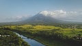 Hillside river at erupt volcano: green grass shore at Philippines countryside aerial. Fields, valley Royalty Free Stock Photo