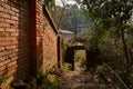 Hillside stairway along red brick wall in 1970s factory