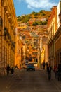 Hillside street view with bright blue car