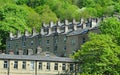 Hillside streets of tall stone houses set in the woodland landscape in hebden bridge west yorkshire Royalty Free Stock Photo