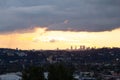 Hillside view of homes and streets with panoramic sky silhouetting downtown skyscrappers Royalty Free Stock Photo