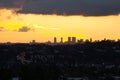 Hillside view of homes and streets with panoramic sky silhouetting downtown skyscrappers Royalty Free Stock Photo