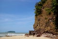 A hillside with a wooden path bridge on the seashore with beach sand scenery in tropical country