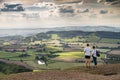 Hillwalkers admire spectacular scenery from atop British camp,hill fort,Herefordshire Beacon