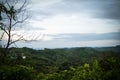 Hilly area with the horizon and sunrise view. Mountain forest area with small tourist spots and a dead tree. Rural tourist spot Royalty Free Stock Photo