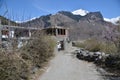 Hilly area snow mountain stone trees village street foot path