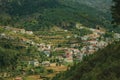 Hilly landscape covered by terraced fields with roofs Royalty Free Stock Photo