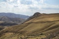 Hilly relief, mountain slopes with sparse vegetation of autumn Caucasus mountains in Armenia Royalty Free Stock Photo