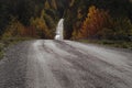 Hilly road through autumn forest Royalty Free Stock Photo