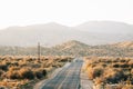 A hilly road and mountains in the desert, in Pioneertown, California Royalty Free Stock Photo