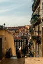 Hilly streets of Lisbon escalator moving stairway near ordinary staircase lifestyle of montanuous city - Lisbon Royalty Free Stock Photo