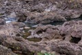 Brown rock river bed above Rainbow falls near Hilo, Hawaii, USA Royalty Free Stock Photo