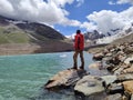 Himachal, India - July 10th, 2022 : Trekker enjoying the view of ghepan lake in himalayas. Picturesque summer landscape. Beauty of