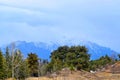 Himalayan Landscape - Blue Mountains with Snowy Summits, Green Trees, and Blue Cloudy Sky - Deoriya Tal, Uttarakhand, India