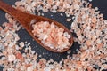 Himalayan pink rock salt in wooden spoon top view