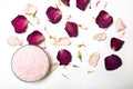 himalayan pink salt and flower petals on white background. Natural cosmetics concept with aroma spa salt Royalty Free Stock Photo