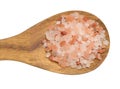 Himalayan pink salt granules in a wooden spoon on an isolated background Royalty Free Stock Photo