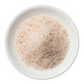 Himalayan pink salt pile in a plate isolated on white top view